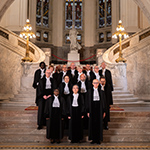 Members of the Court and the Registrar in front of the grand stair case in the Peace Palace